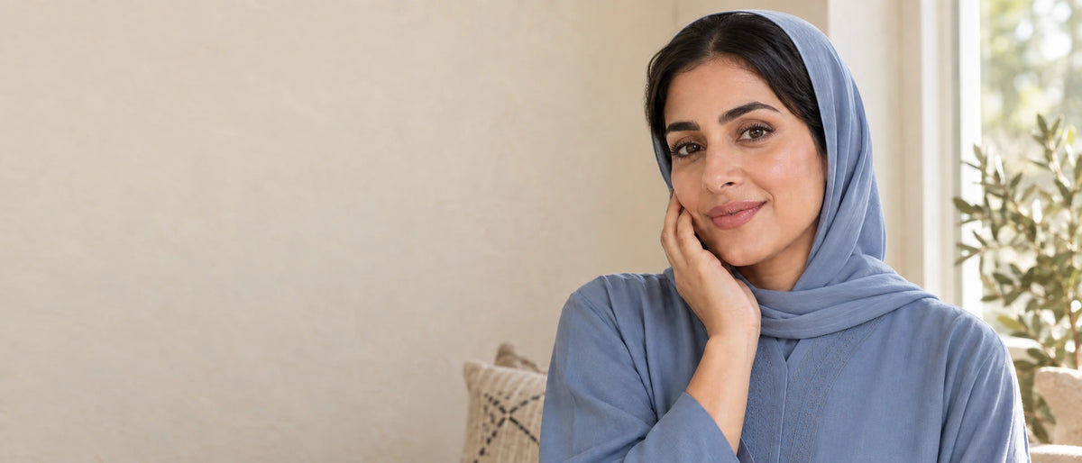 Woman gently touching her cheek in natural daylight