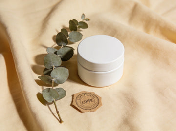 Certified-organic clean beauty — eucalyptus and an unbranded jar